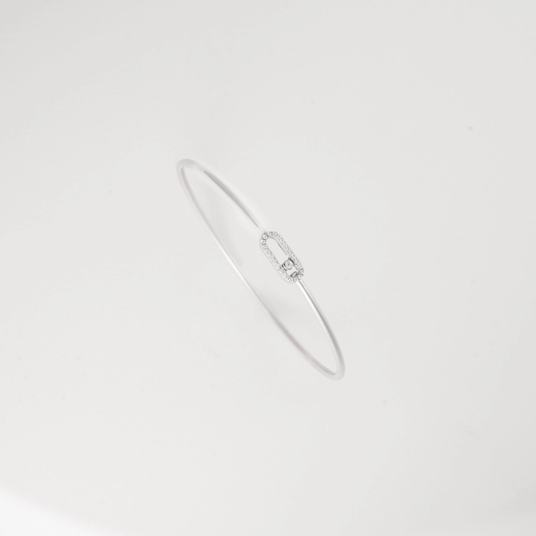 The sleek oval design creates a flattering silhouette around your wrist, complementing both casual and formal outfits with understated charm.