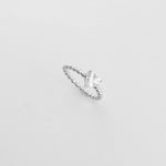 The Heart Solitaire ring features a radiant heart-cut stone resting on a silver bead-style band.