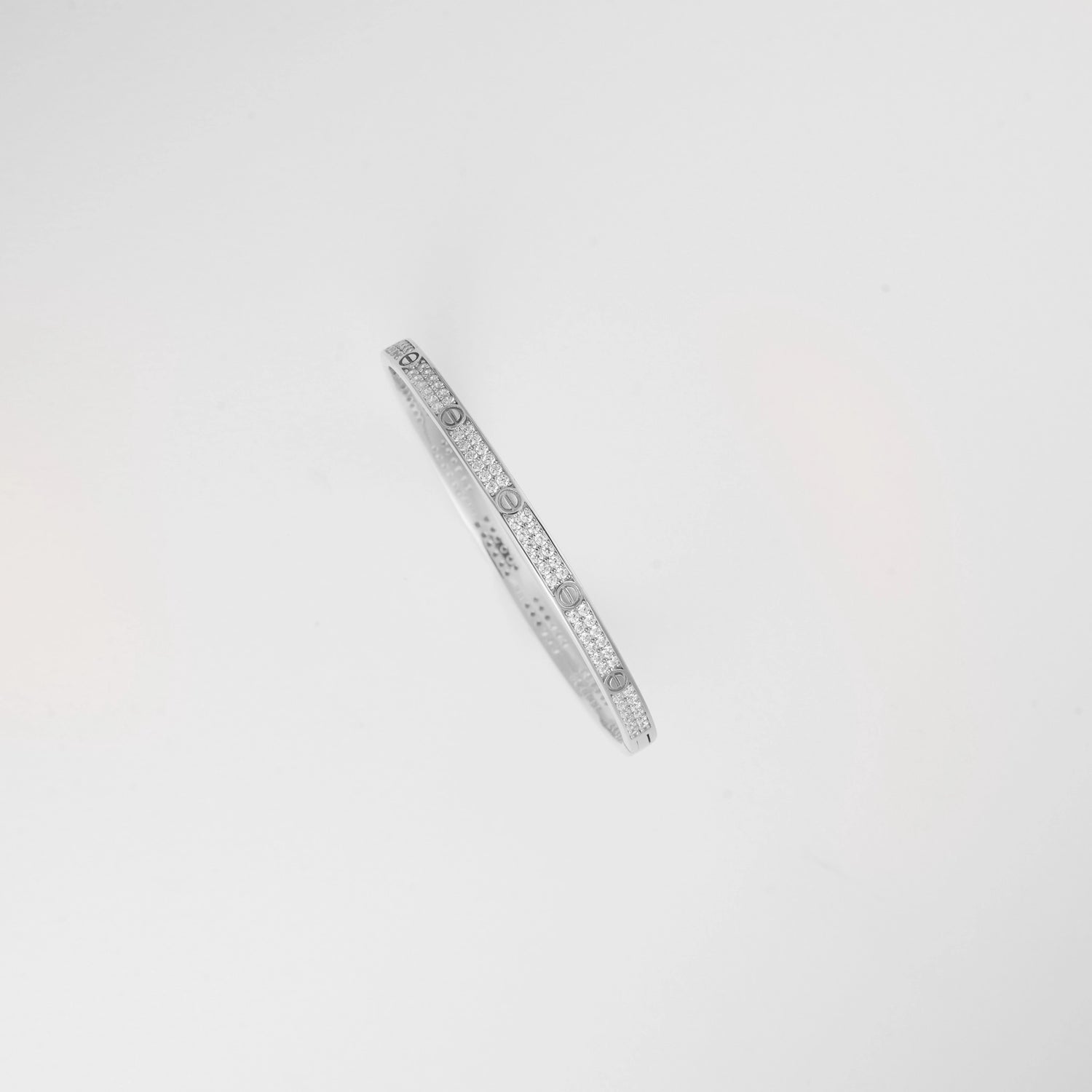 Designed with elegance and strength, the Lock'd in Silver Bangle features a secure clasp and a band of sparkling stones.