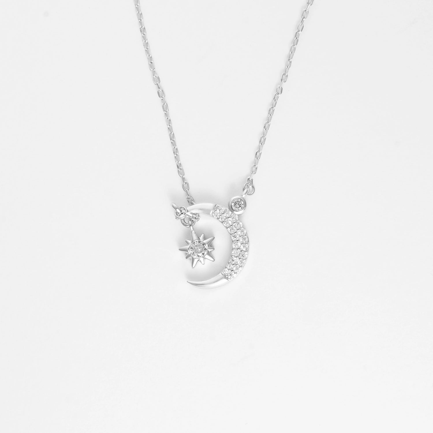 The Moon and Star Necklace is a delicate expression of celestial beauty. Crafted from fine silver and adorned with brightening zircon stones, the crescent moon gently cradles a sparkling star, creating a piece that feels both magical and timeless.