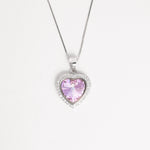 Elegant and full of charm, the Pink Heart Crystal Necklace ;features a radiant light-pink heart-shaped crystal framed by a halo of sparkling zircon stones.