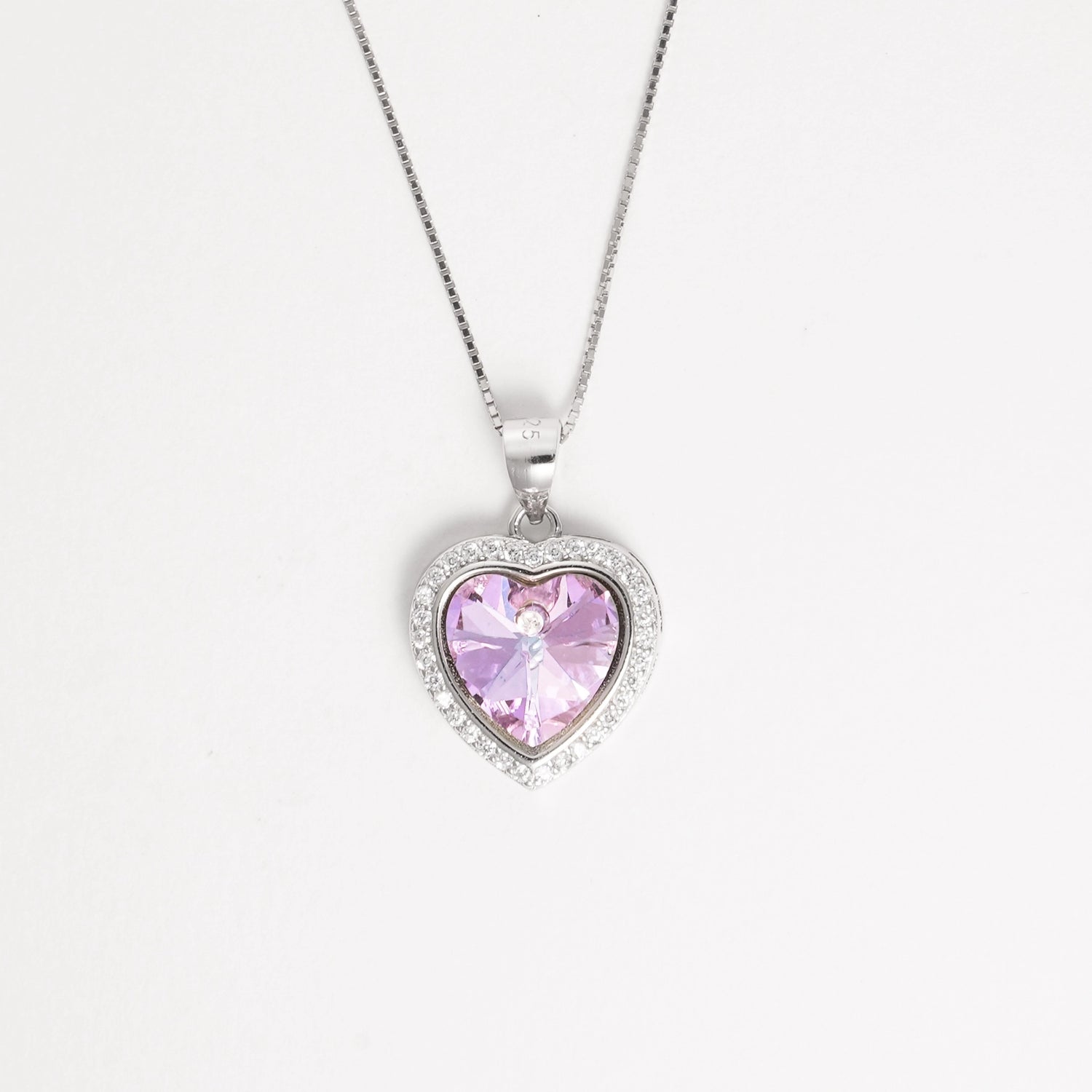 Elegant and full of charm, the Pink Heart Crystal Necklace ;features a radiant light-pink heart-shaped crystal framed by a halo of sparkling zircon stones.