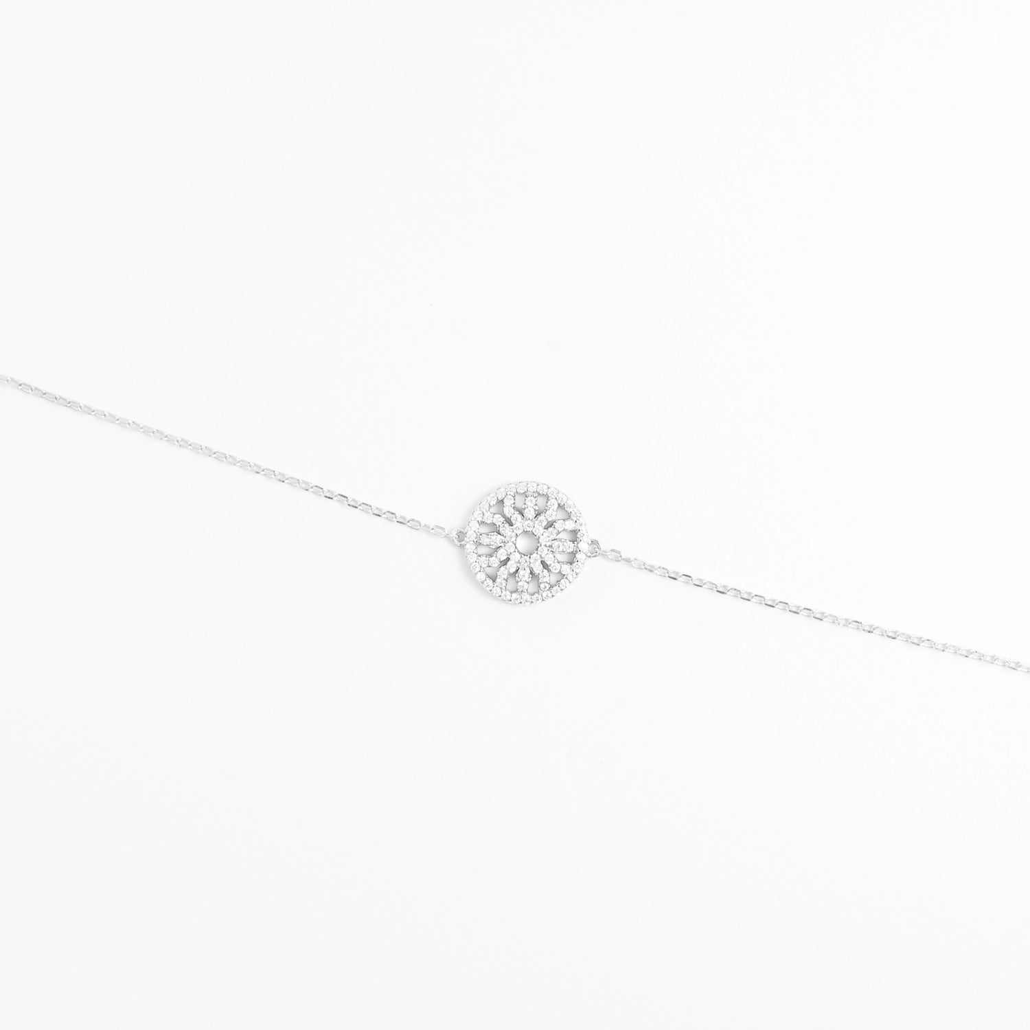 The Radiant Circle Bracelet features a beautifully crafted round charm filled with bright zircon stones and delicate crystals.