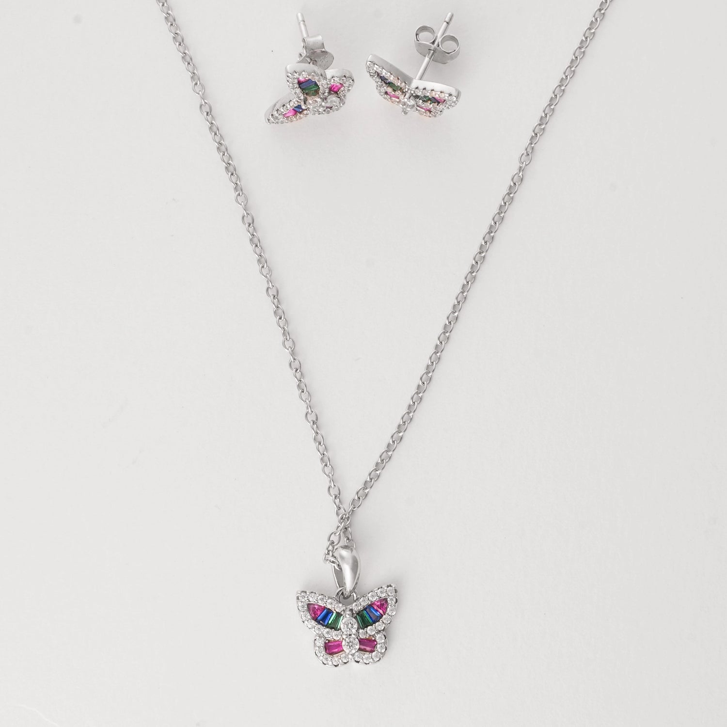  Crafted from fine silver and accented with sparkling zircon stones, this charming set features a delicate butterfly design filled with vibrant rainbow colors. 