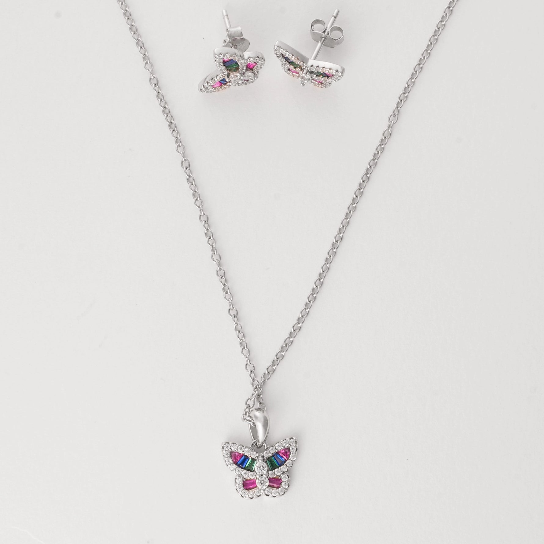  Crafted from fine silver and accented with sparkling zircon stones, this charming set features a delicate butterfly design filled with vibrant rainbow colors. 