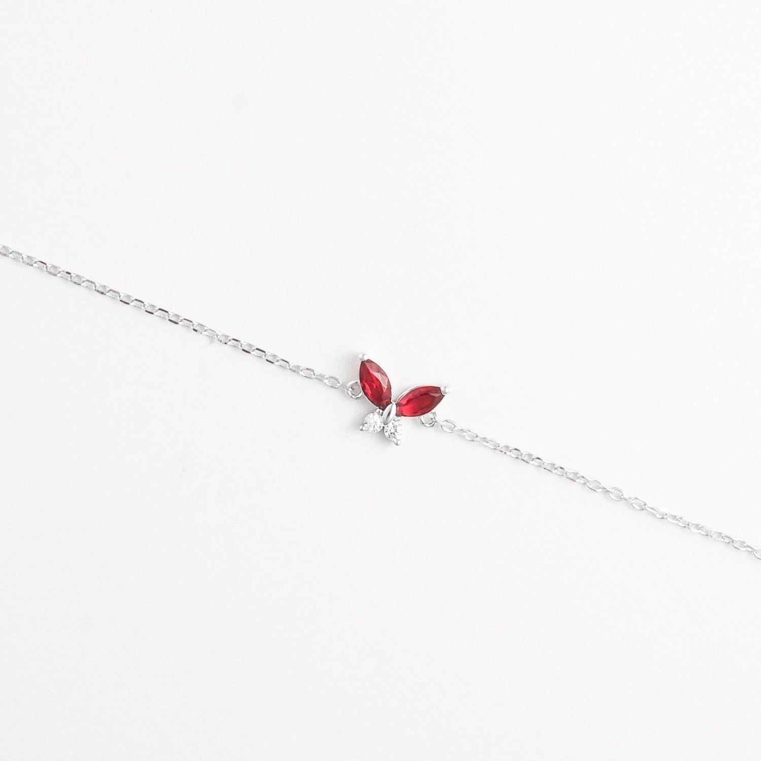 The Red Leaf Bracelet features two vibrant marquise-cut red stones shaped like delicate leaves, paired with shimmering zircon crystals.