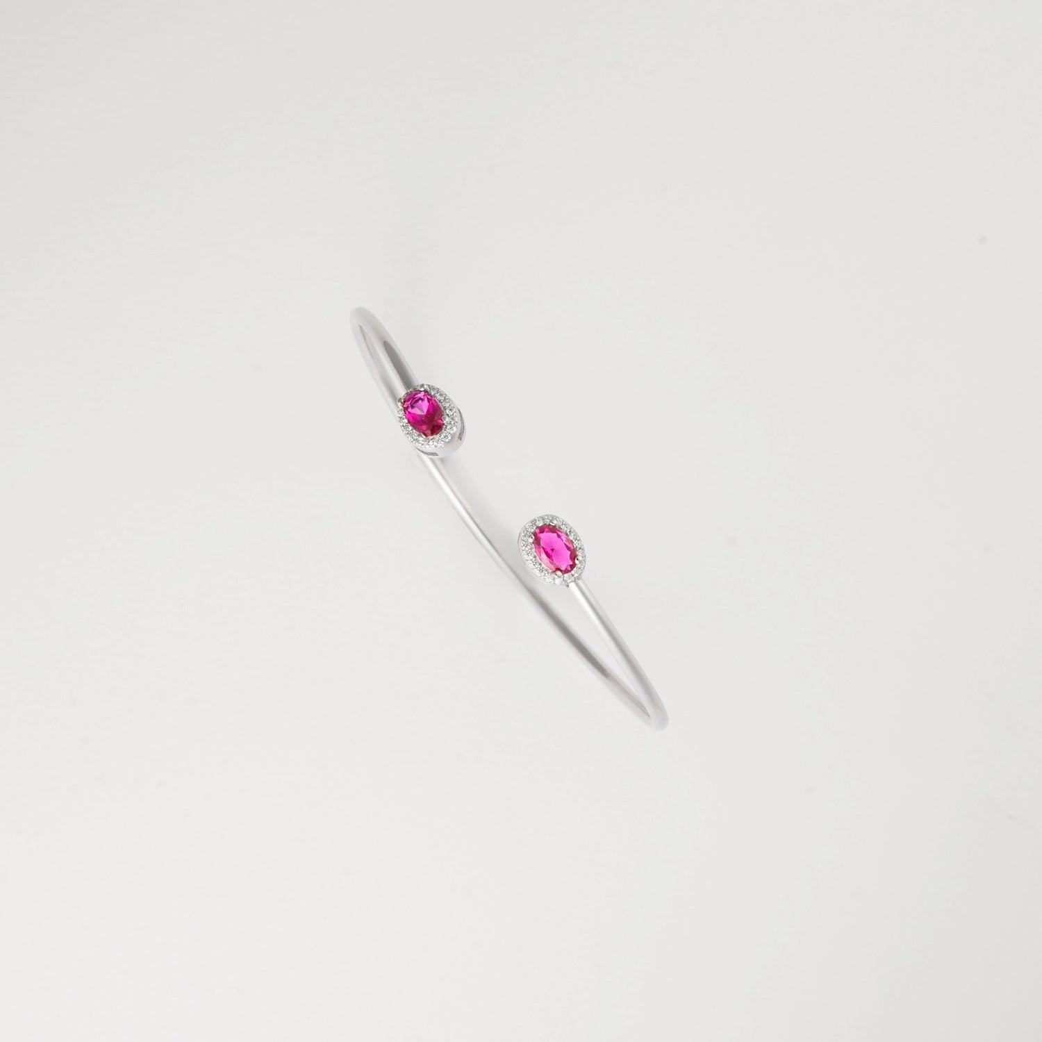 his sleek Red Mirage Silver Bangle features two oval red crystal stones, each framed with delicate sparkling stones. Light, elegant, and easy to wear