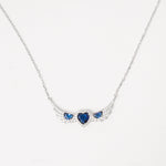 A symbol of love and elegance, the Sapphire Heart Trio Wing Necklace features three dazzling blue heart crystals embraced by wing-like curves of shimmering zircon stones. Set in pure silver, its winged design brings a graceful lift to any look.