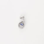 Elegant and effortlessly unique, the Sapphire Twist Pendant brings a fresh summer feel to your look. Crafted from fine silver, this piece features a delicate teardrop twist design cradling a deep ocean-blue crystal at its center.