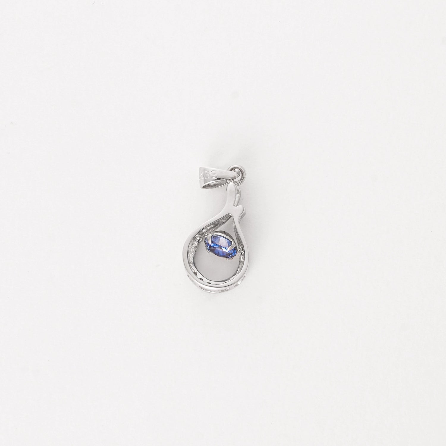 Elegant and effortlessly unique, the Sapphire Twist Pendant brings a fresh summer feel to your look. Crafted from fine silver, this piece features a delicate teardrop twist design cradling a deep ocean-blue crystal at its center.