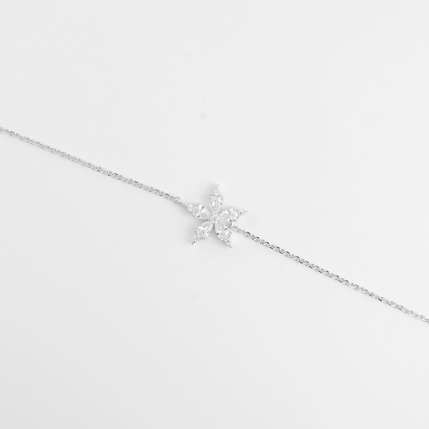 The Sparkling Star Bracelet features a delicate silver chain with a radiant star-shaped charm at its center. 