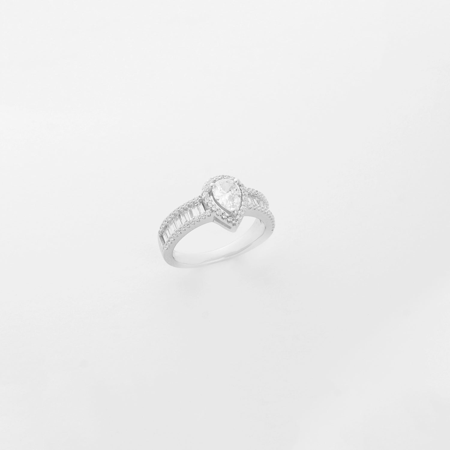 a stunning silver solitaire ring featuring a beautifully crafted, tear-shaped crystal stone, accented delicately with sparkling zircon details.
