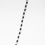 the Teardrop Black Tennis Bracelet, a stunning accessory crafted from fine silver and adorned with sparkling zircon stones. The unique teardrop-shaped black zircon stones alternate with bright clear zircons, creating a chic and elegant look.