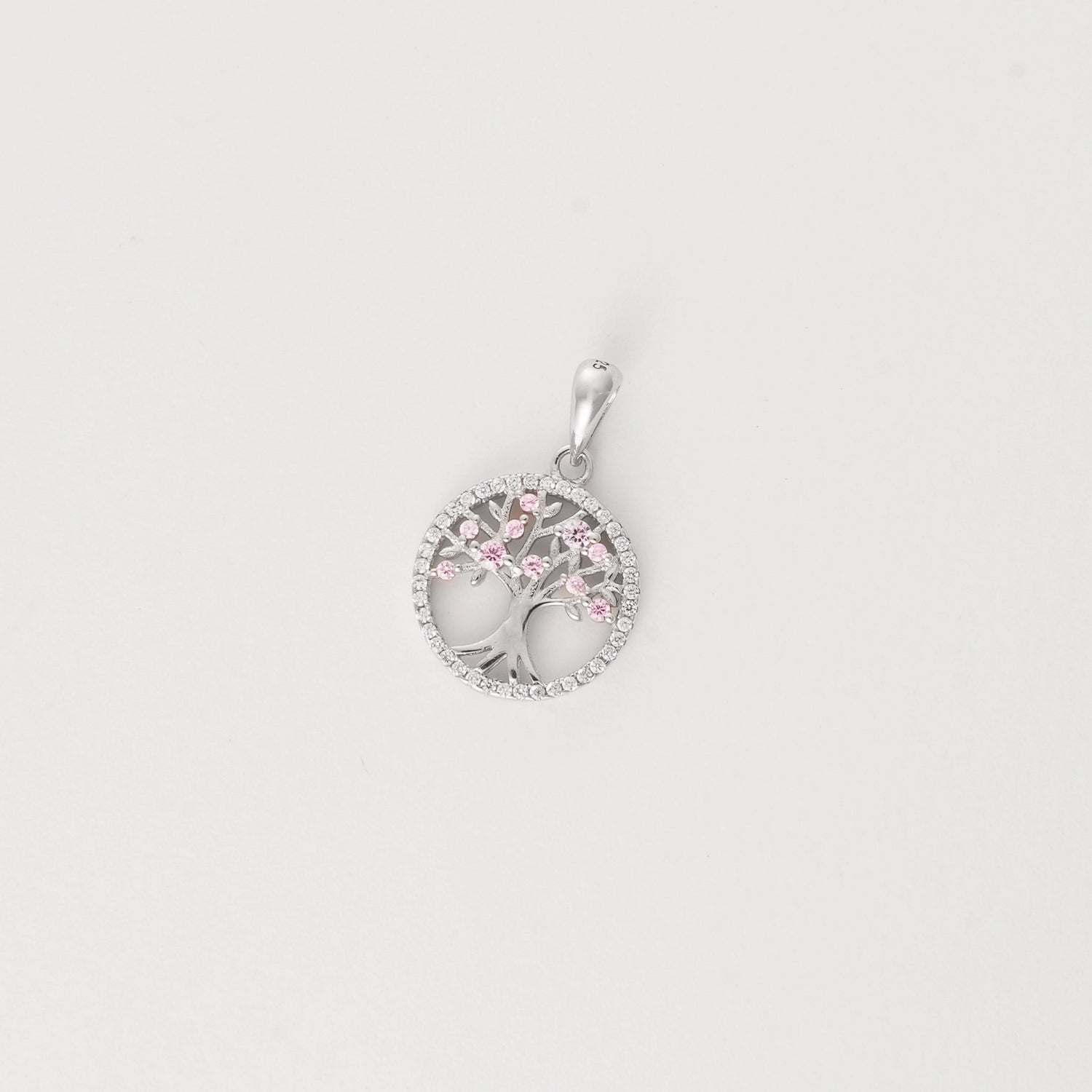Celebrate growth, beauty, and sunshine with the Tree of Life Pendant. Crafted from fine silver, this elegant piece features a delicate tree design accented with sparkling pink zircon stones that bloom like summer blossoms.