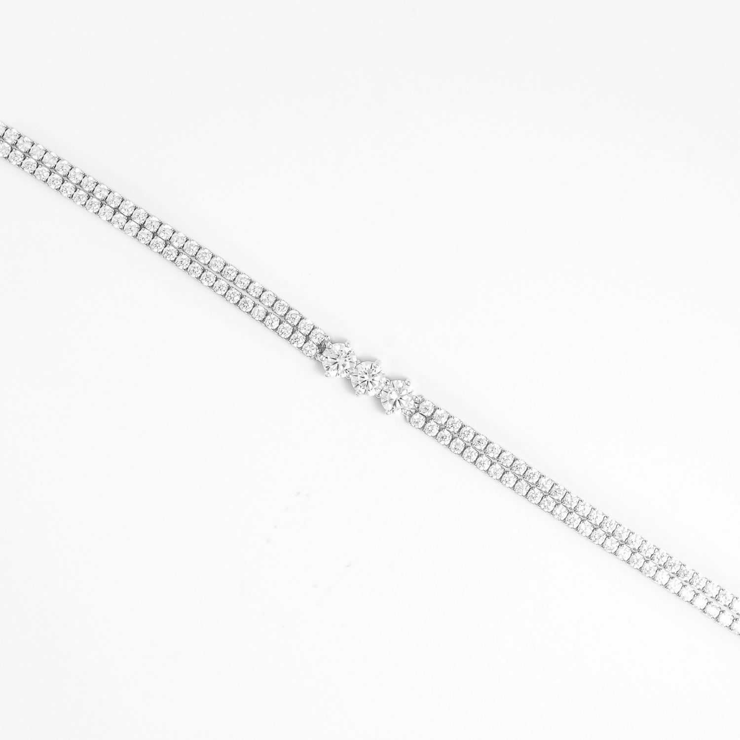 The Triple Glow Silver Bracelet features two rows of bright zircon stones leading to a stunning trio of larger center crystals.