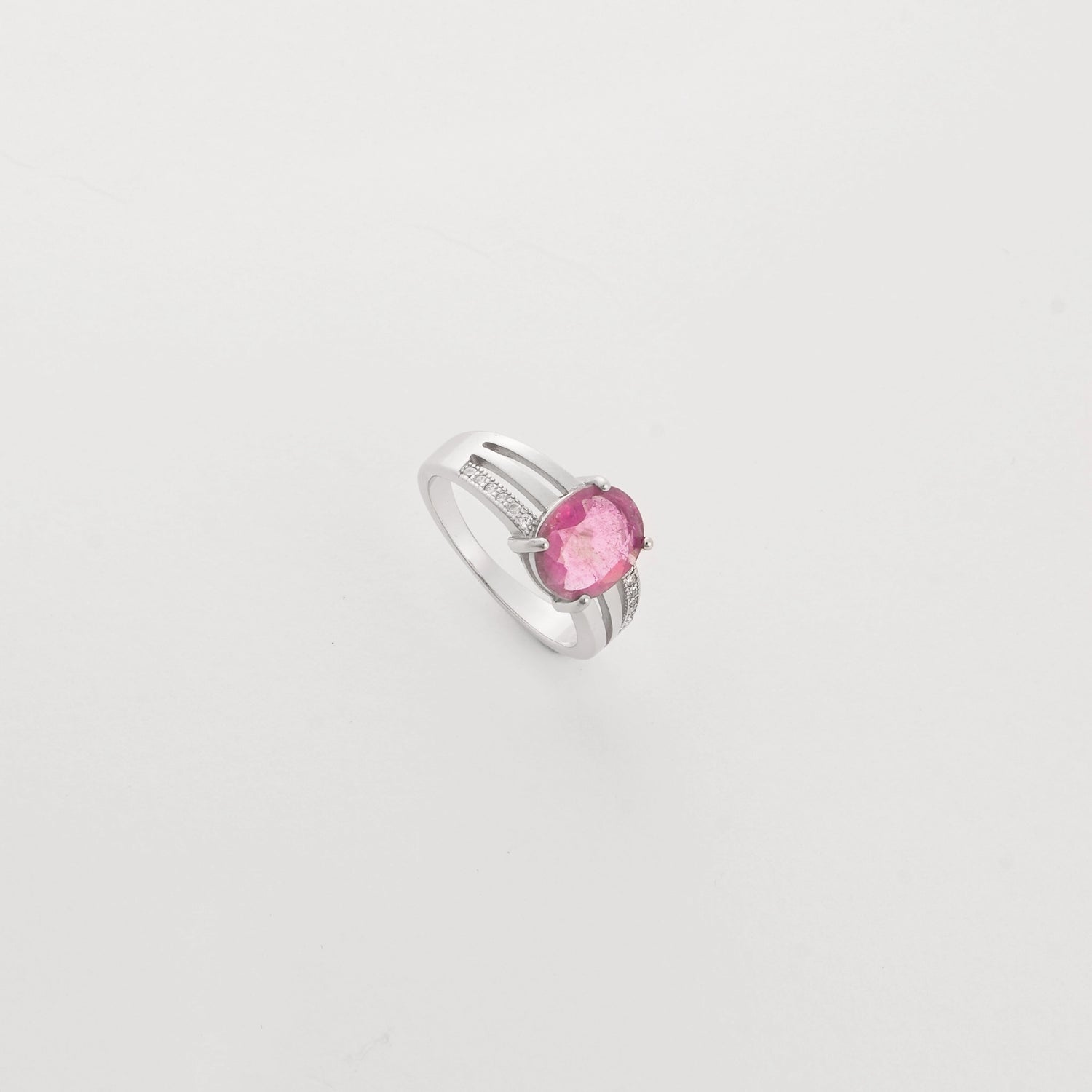 he Ruby Aura ring features a vivid, real ruby gemstone set on a modern silver band. Framed with rows of bright zircon stones, it blends classic charm with a fresh, elegant style.
